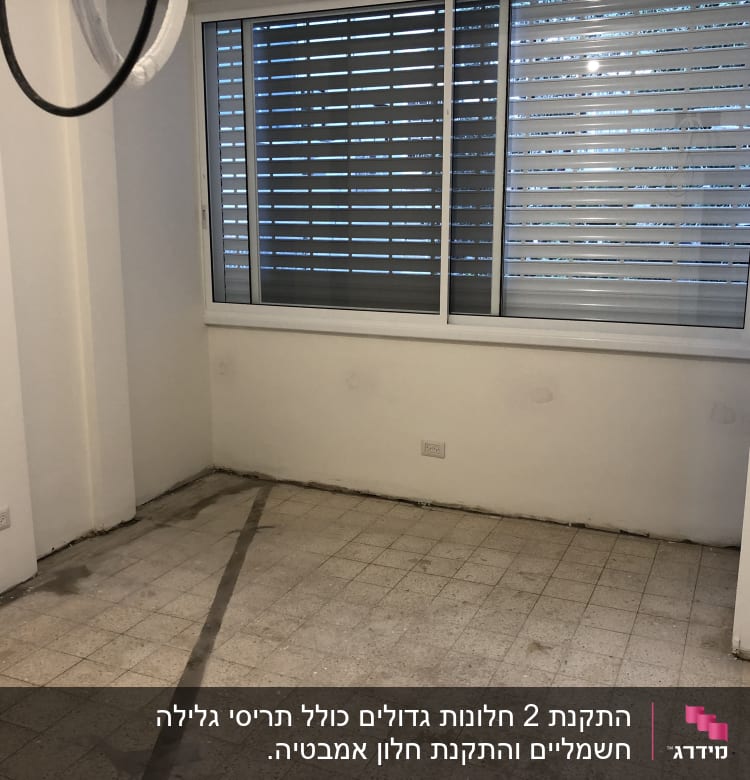 חלון עם תריסי אלומיניום בחדר ריק